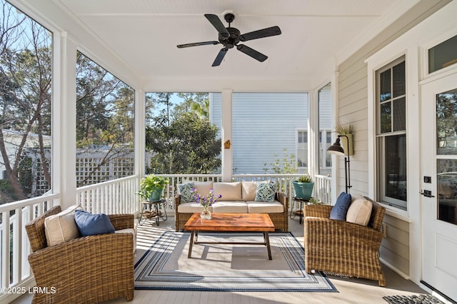 sunroom / solarium with a ceiling fan and a healthy amount of sunlight