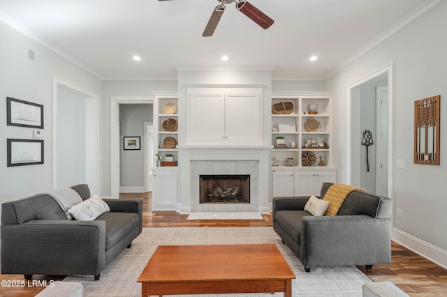 living area featuring light wood-style floors, baseboards, crown molding, and recessed lighting