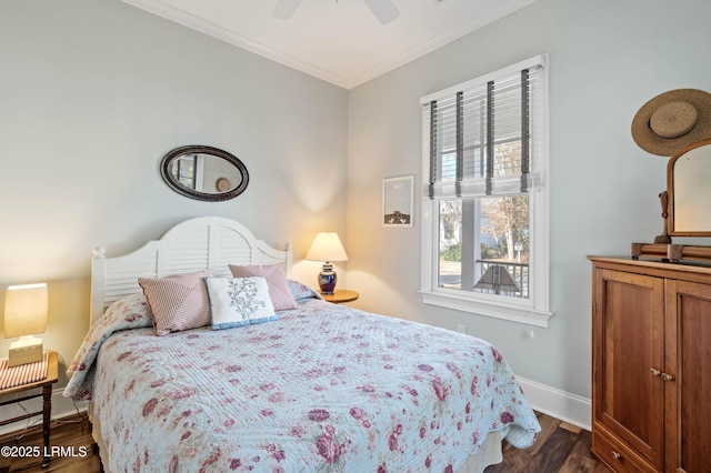 bedroom featuring baseboards, ornamental molding, dark wood finished floors, and a ceiling fan