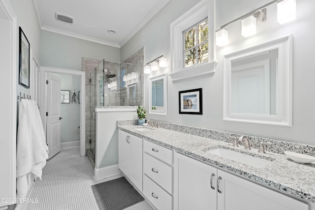 bathroom featuring a shower stall, a sink, visible vents, and crown molding