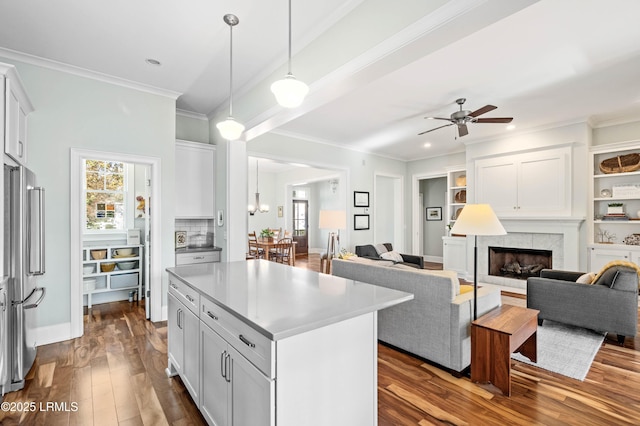 kitchen featuring open floor plan, light countertops, and white cabinets