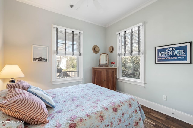 bedroom with ceiling fan, dark wood-style flooring, visible vents, baseboards, and ornamental molding