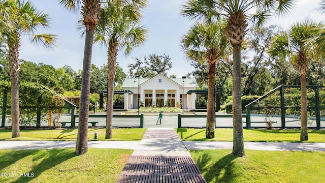 view of property's community featuring a yard and fence