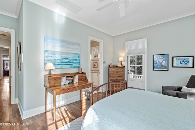 bedroom with wood finished floors, visible vents, baseboards, ensuite bath, and crown molding