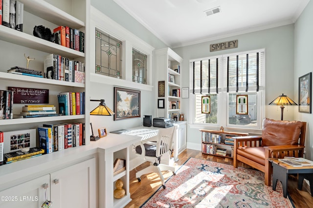 living area featuring ornamental molding, visible vents, and light wood-style floors