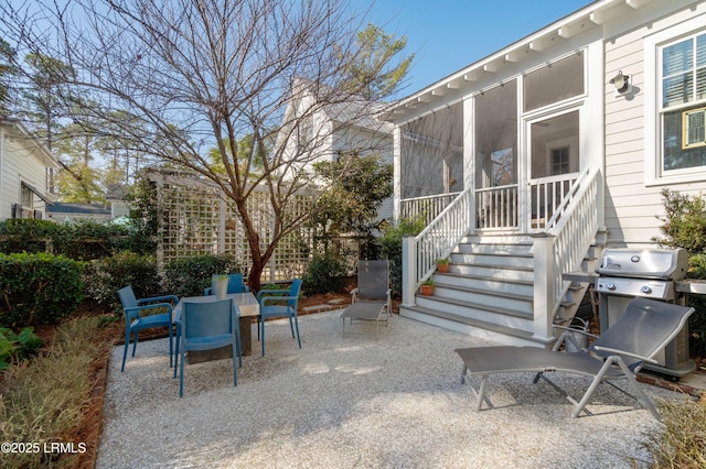 view of patio with a sunroom, outdoor dining area, and grilling area