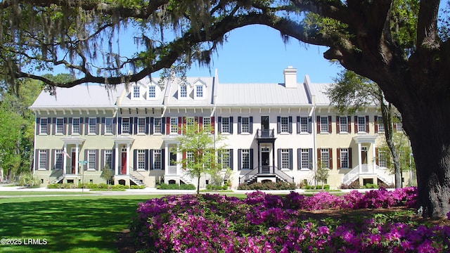 view of front facade with a front lawn and a chimney