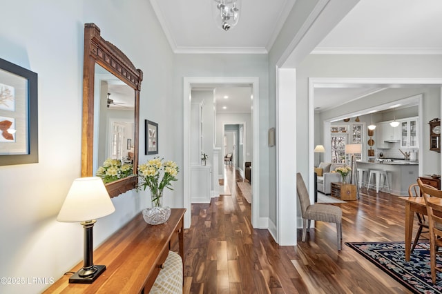 interior space with dark wood-style floors, crown molding, and baseboards