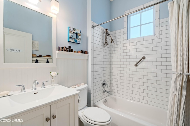 full bathroom with toilet, vanity, shower / tub combo with curtain, and wainscoting