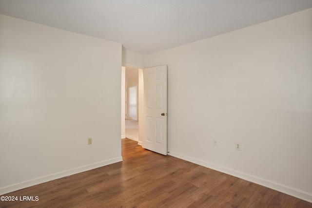 empty room with dark hardwood / wood-style floors