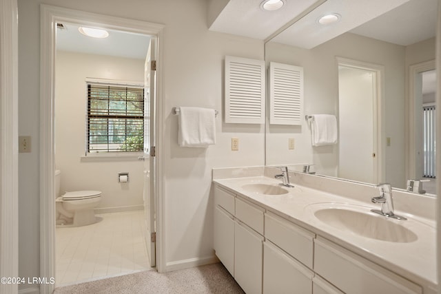 bathroom featuring vanity and toilet