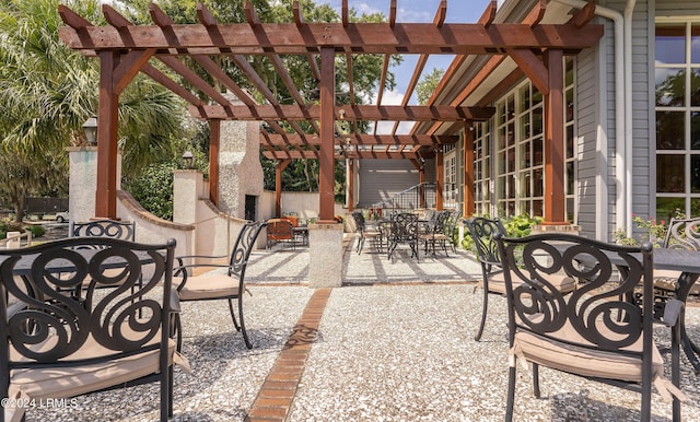 view of patio / terrace featuring exterior fireplace and a pergola