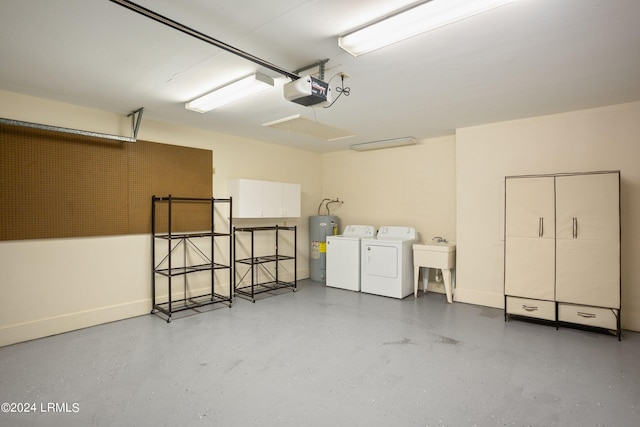 garage featuring a garage door opener, washing machine and dryer, and electric water heater