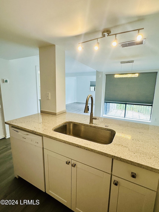 kitchen featuring white cabinetry, sink, dark hardwood / wood-style flooring, light stone counters, and white dishwasher