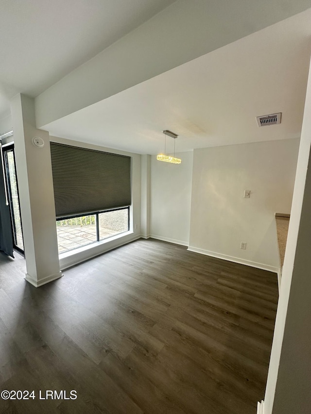 empty room featuring dark hardwood / wood-style flooring