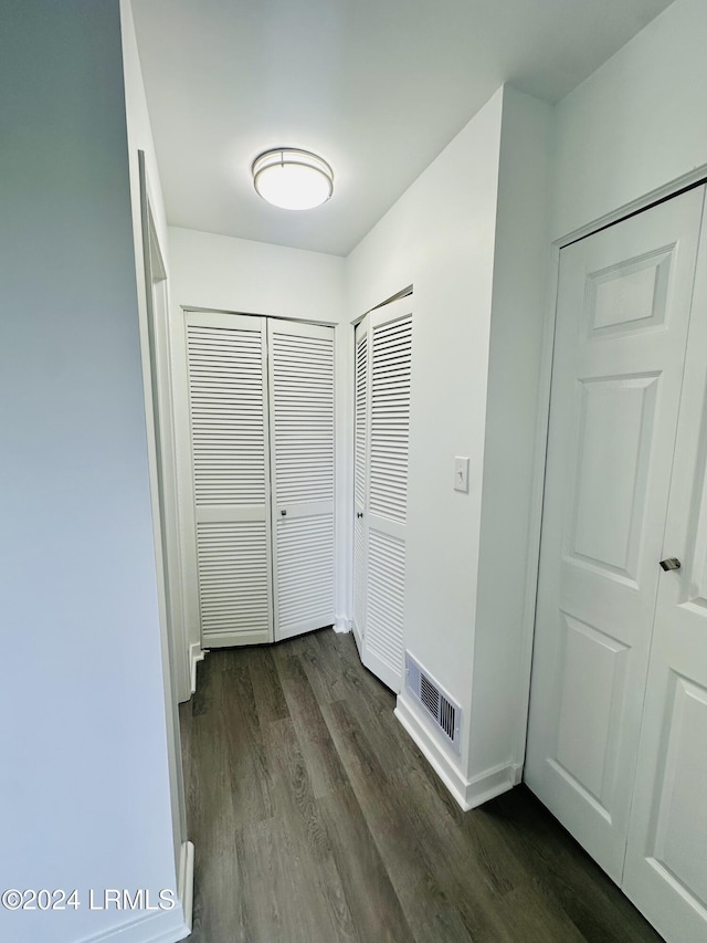 hall featuring dark wood-type flooring