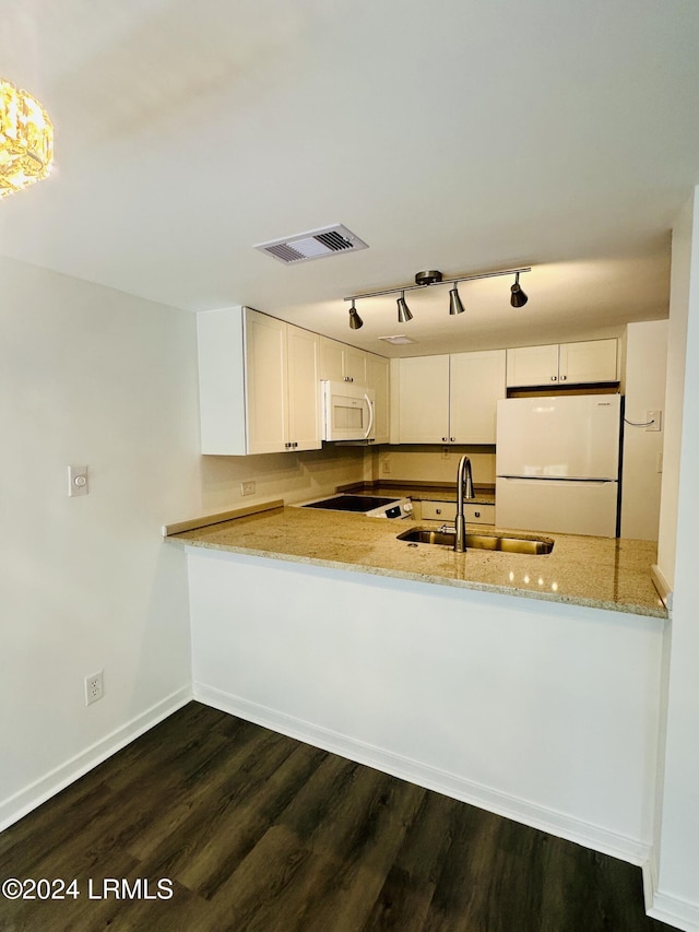 kitchen with sink, white cabinetry, kitchen peninsula, white appliances, and light stone countertops