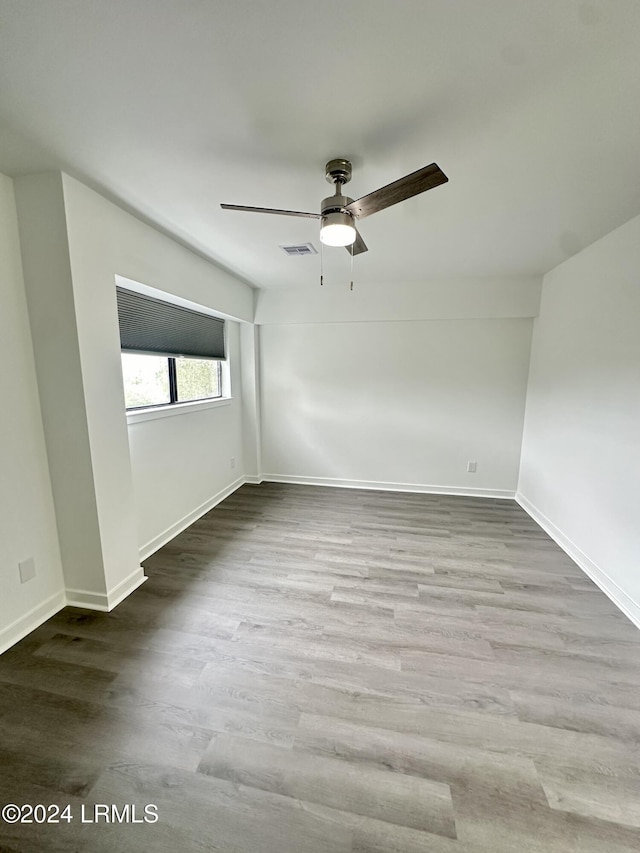 unfurnished room featuring hardwood / wood-style flooring and ceiling fan