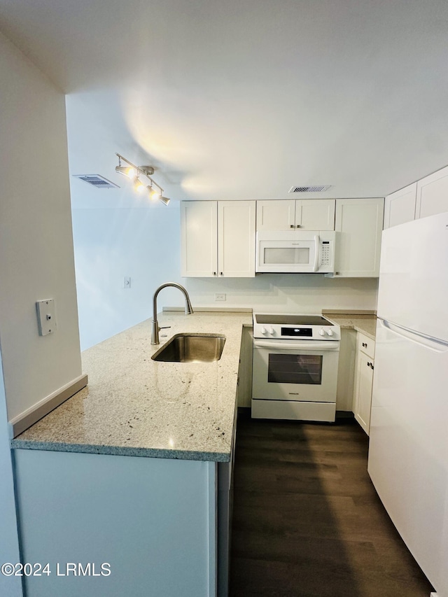 kitchen featuring white cabinetry, sink, kitchen peninsula, light stone countertops, and white appliances