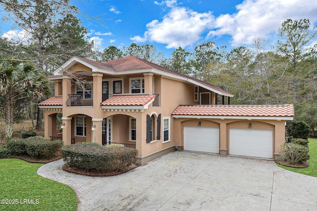 mediterranean / spanish-style home featuring a garage and a balcony