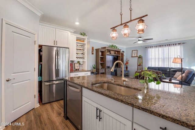 kitchen featuring white cabinetry, appliances with stainless steel finishes, sink, and dark stone countertops