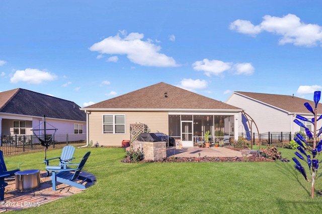 back of house featuring a sunroom, area for grilling, a lawn, and a patio area