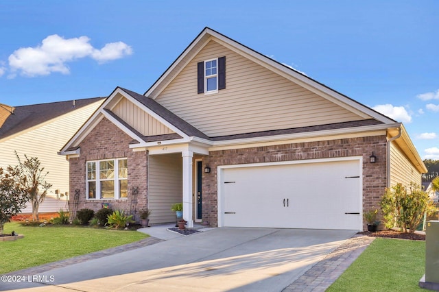 craftsman house with a garage and a front lawn