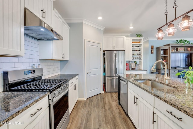 kitchen featuring sink, decorative light fixtures, white cabinets, and appliances with stainless steel finishes