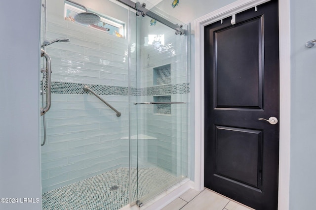 bathroom with tile patterned floors and a shower with shower door