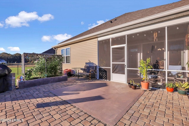 view of patio with a sunroom