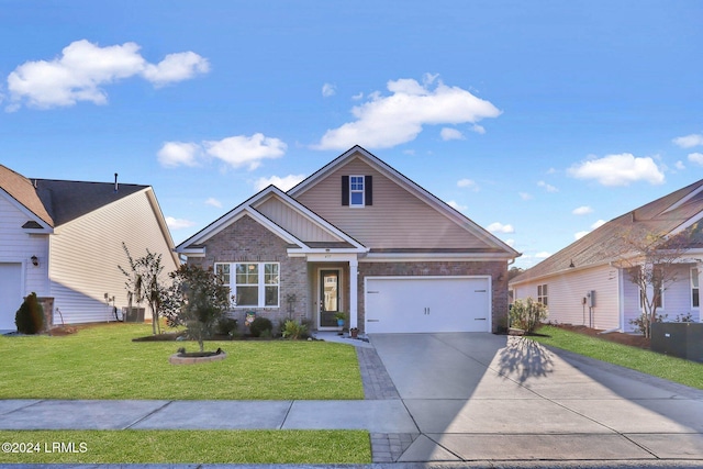 view of front of house with cooling unit, a garage, and a front yard