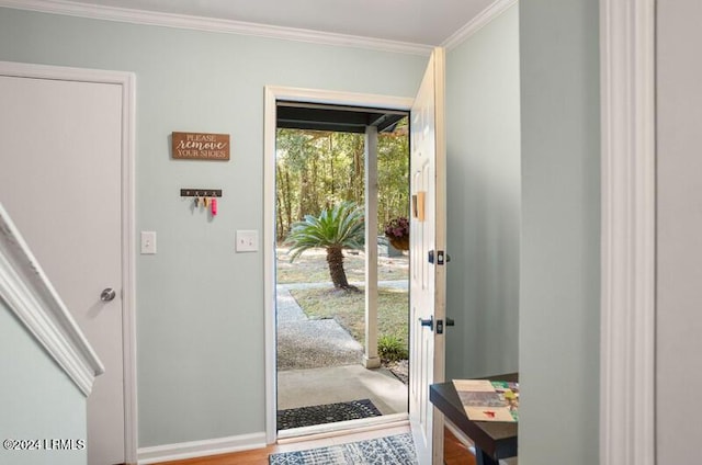 doorway to outside with hardwood / wood-style flooring and ornamental molding