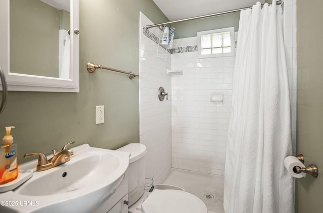 bathroom with sink, toilet, and a shower with shower curtain