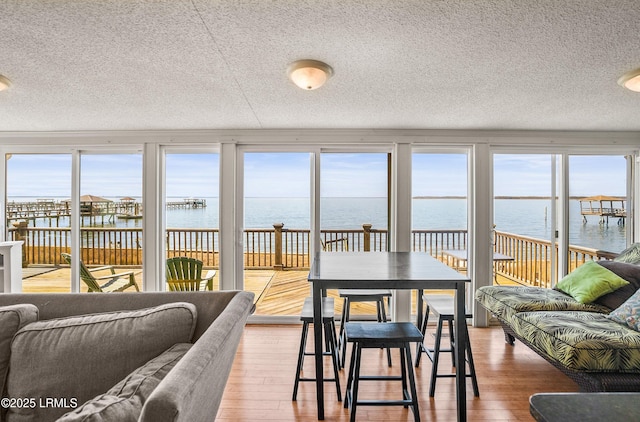 sunroom / solarium featuring a water view