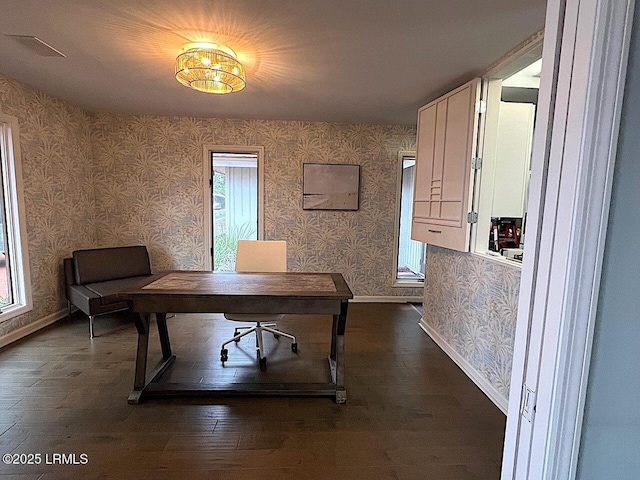 office area with dark wood-type flooring, baseboards, and wallpapered walls