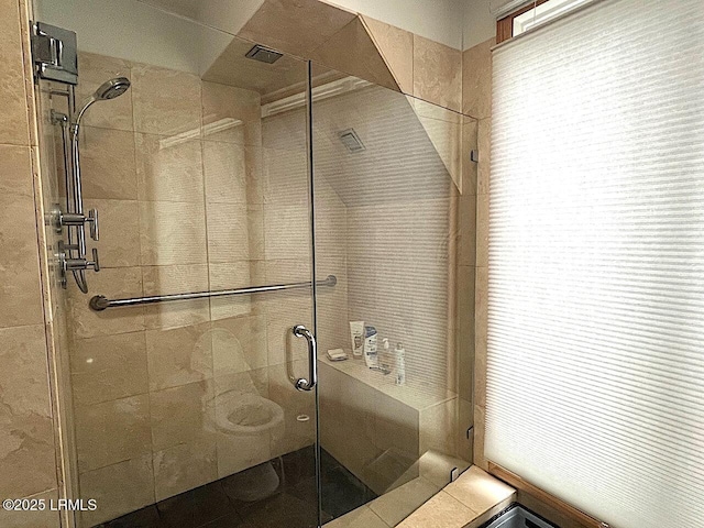 full bath with a shower stall and toilet