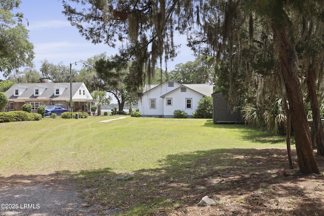 1413 Pigeon Point Rd, Beaufort, SC 29902 - view of grassy yard featuring a storage shed and an outbuilding