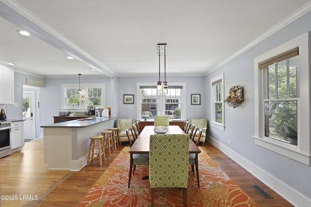 1413 Pigeon Point Rd, Beaufort, SC 29902 - dining area featuring recessed lighting, wood finished floors, ornamental molding, and baseboards