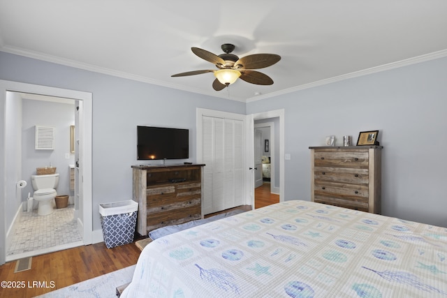 1413 Pigeon Point Rd, Beaufort, SC 29902 - bedroom with crown molding, wood finished floors, a closet, baseboards, and ensuite bath
