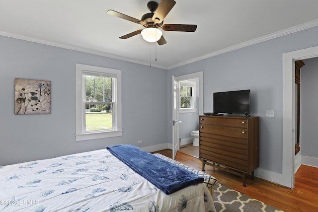 1413 Pigeon Point Rd, Beaufort, SC 29902 - bedroom featuring wood finished floors, crown molding, baseboards, a ceiling fan, and ensuite bath