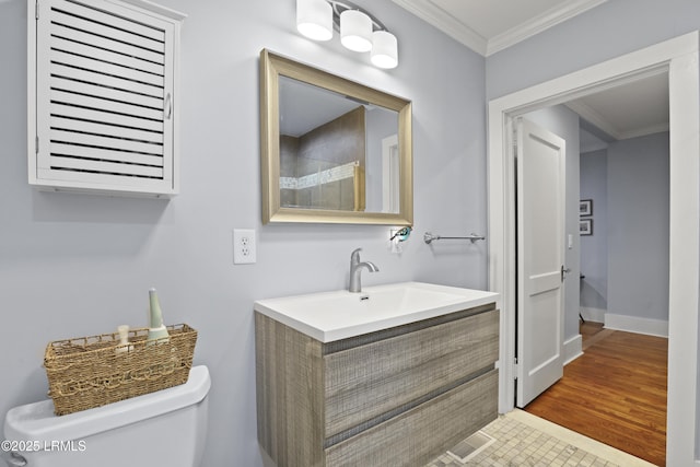 1413 Pigeon Point Rd, Beaufort, SC 29902 - full bathroom featuring toilet, crown molding, vanity, tiled shower, and baseboards