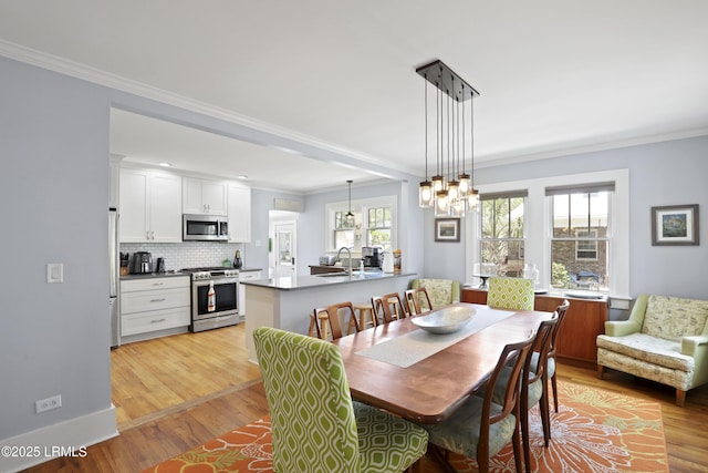 1413 Pigeon Point Rd, Beaufort, SC 29902 - dining area with light wood-type flooring and ornamental molding