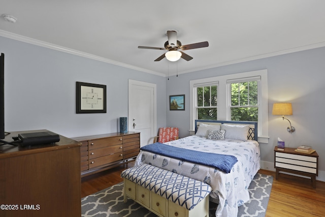 1413 Pigeon Point Rd, Beaufort, SC 29902 - bedroom with ornamental molding, wood finished floors, baseboards, and a ceiling fan