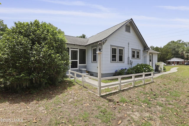 1413 Pigeon Point Rd, Beaufort, SC 29902 - view of side of property featuring fence and roof with shingles