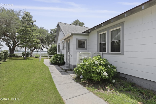 1413 Pigeon Point Rd, Beaufort, SC 29902 - view of property exterior featuring a yard and roof with shingles