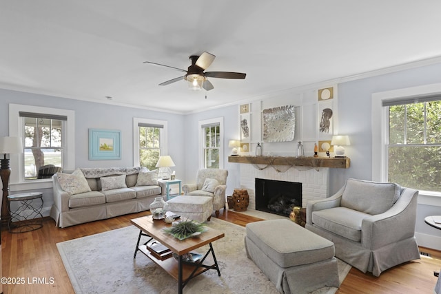 1413 Pigeon Point Rd, Beaufort, SC 29902 - living area with crown molding, a fireplace, ceiling fan, and wood finished floors