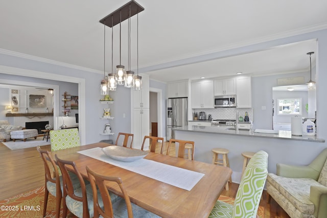 1413 Pigeon Point Rd, Beaufort, SC 29902 - dining space featuring wood finished floors and crown molding