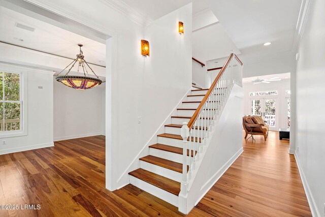 104 Barnaby Blf, Seabrook, SC 29940 - stairway with a chandelier, healthy amount of natural light, wood-type flooring, crown molding, and recessed lighting