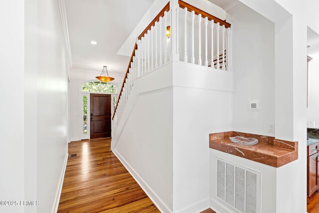 104 Barnaby Blf, Seabrook, SC 29940 - hall with stairs, wood finished floors, crown molding, and recessed lighting