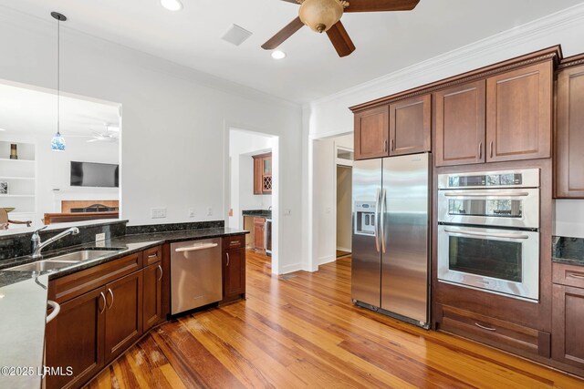 104 Barnaby Blf, Seabrook, SC 29940 - kitchen with appliances with stainless steel finishes, a ceiling fan, ornamental molding, light wood finished floors, and hanging light fixtures
